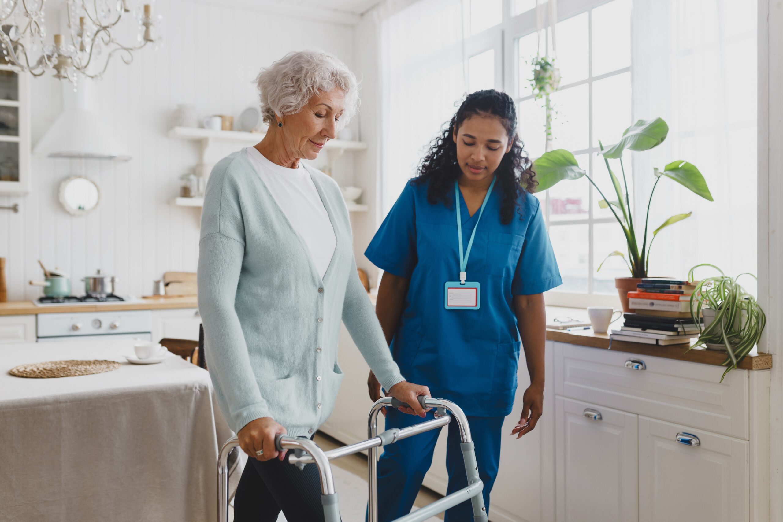 Woman on walker with carer in home
